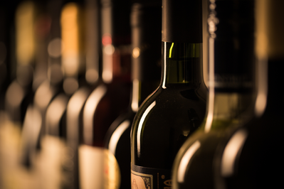 wine bottles lined up on a shelf