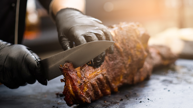 chef slicing smoked meat