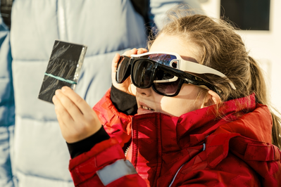 young girl watching eclipse