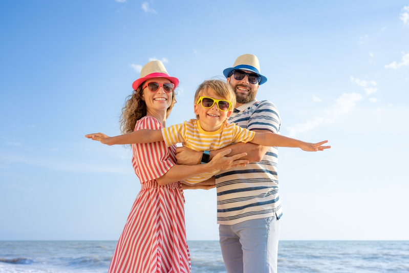 family at beach with kid